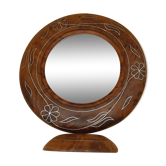 Antique mirror on wooden stand and metal net