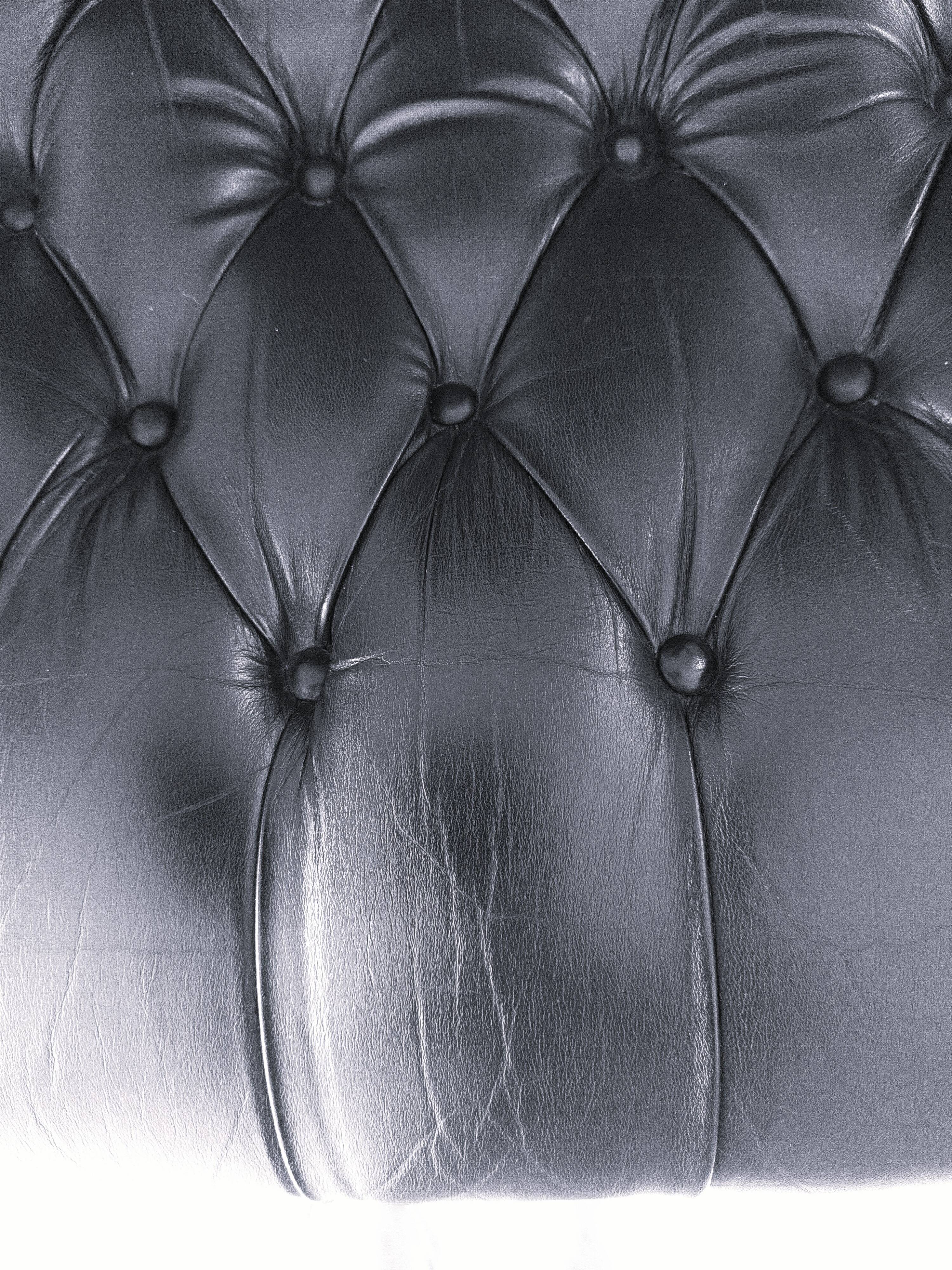 Black leather rocking Chesterfield armchair