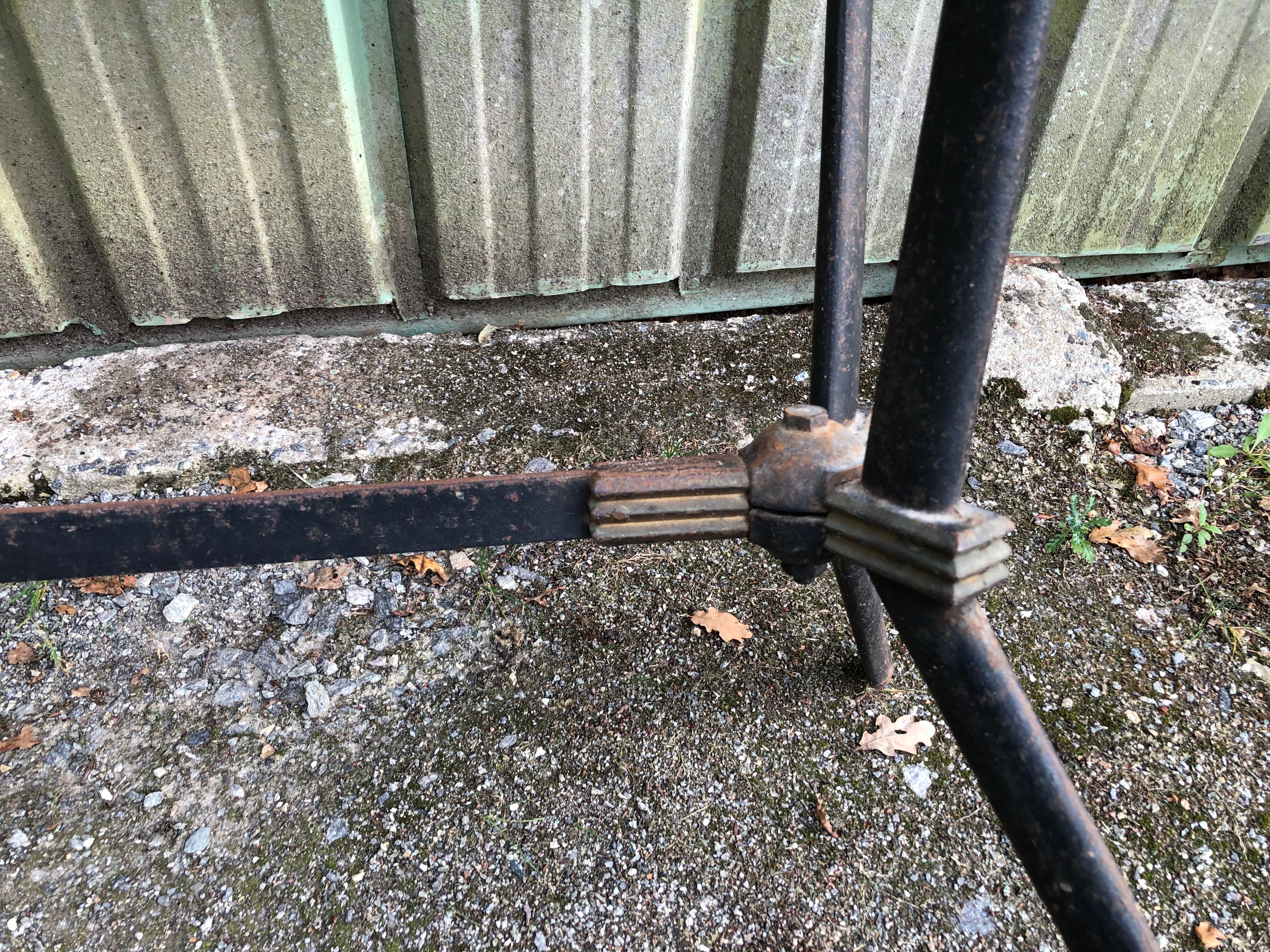 Vintage bistro table with an Art Deco style cast iron base and Formica top.