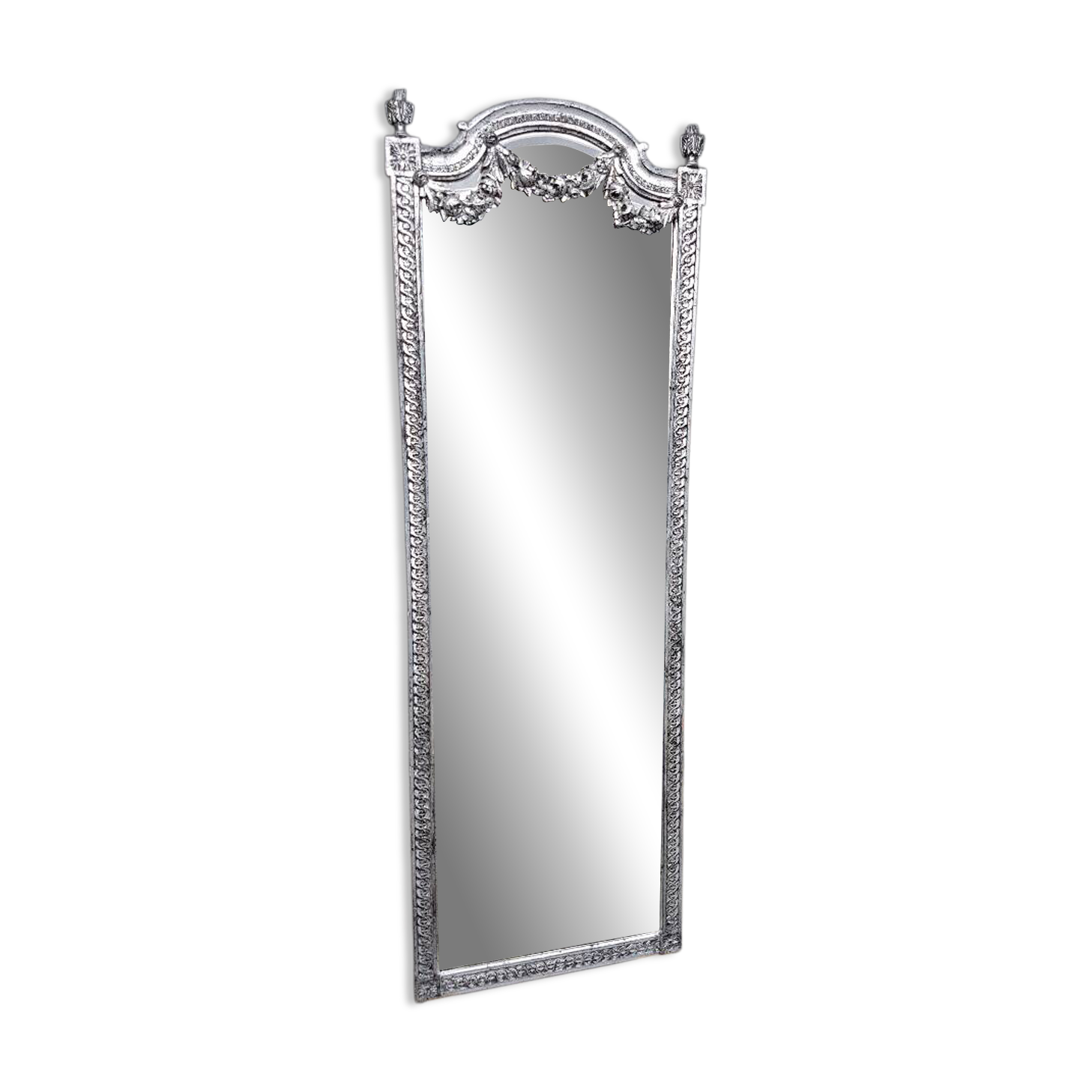 Carved and silvered wooden mirror in the Louis XVI style.