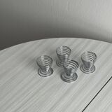 Set of 4 designer egg cups in shiny silver metal