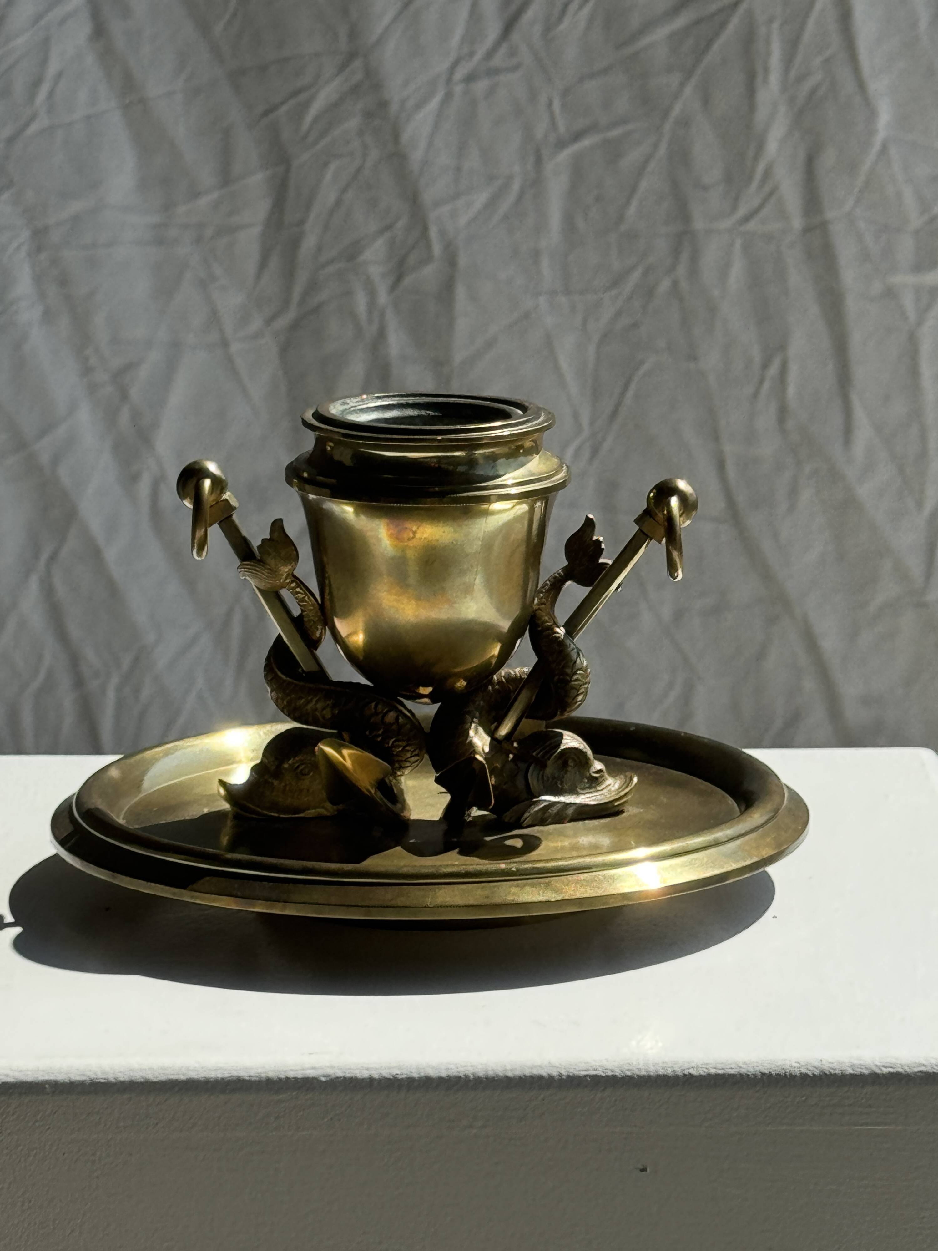 Large 19th century brass candlestick with dolphin motifs