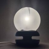 Small black wooden table lamp with frosted glass globe