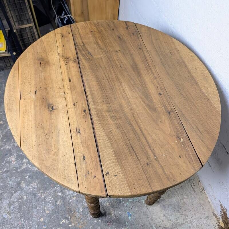 Antique wooden drop-leaf table with turned legs.