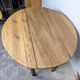 Antique wooden drop-leaf table with turned legs.