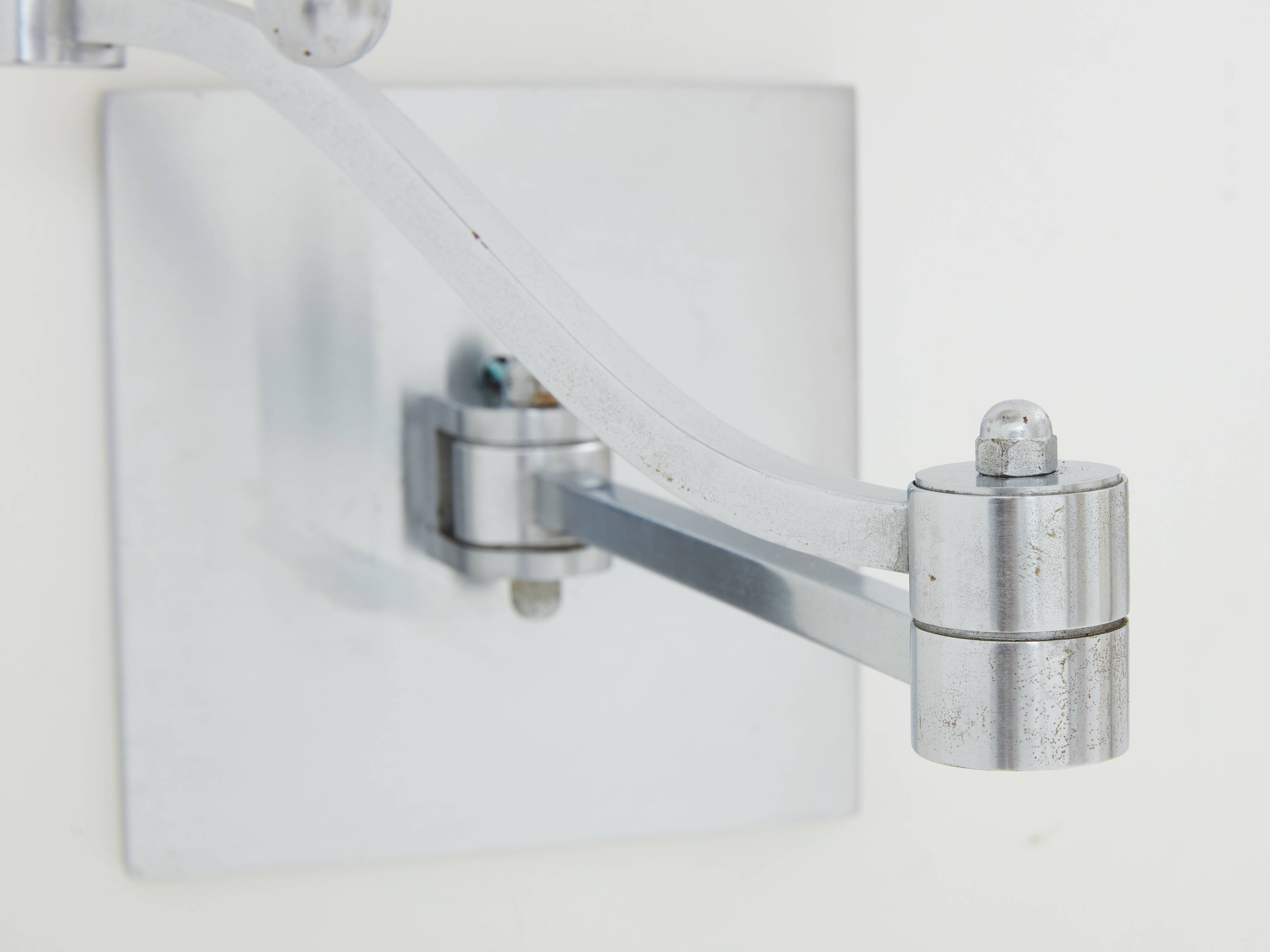 Pair of Maison Charles adjustable brushed steel wall lights circa 1960