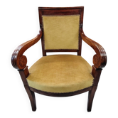 Fauteuil à accotoirs volutes et pieds sabre en velours moutarde XIXe