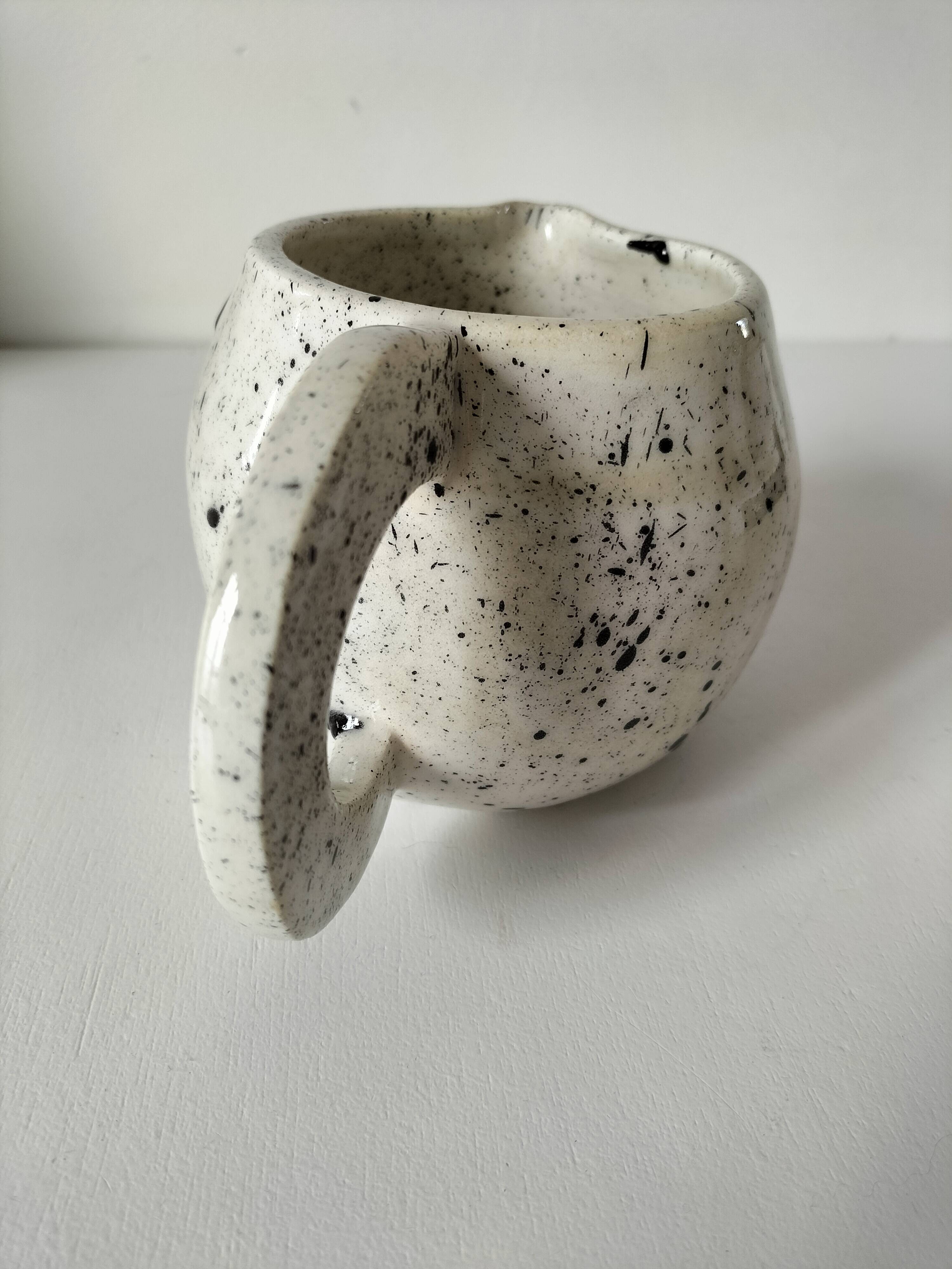 Small speckled ceramic jug in a vintage workshop style.