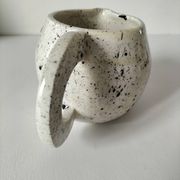 Small speckled ceramic jug in a vintage workshop style.