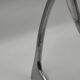 Chromed sculptural art object, abstract modernist shape in metal, contemporary design accent, brutalist interior decoration.