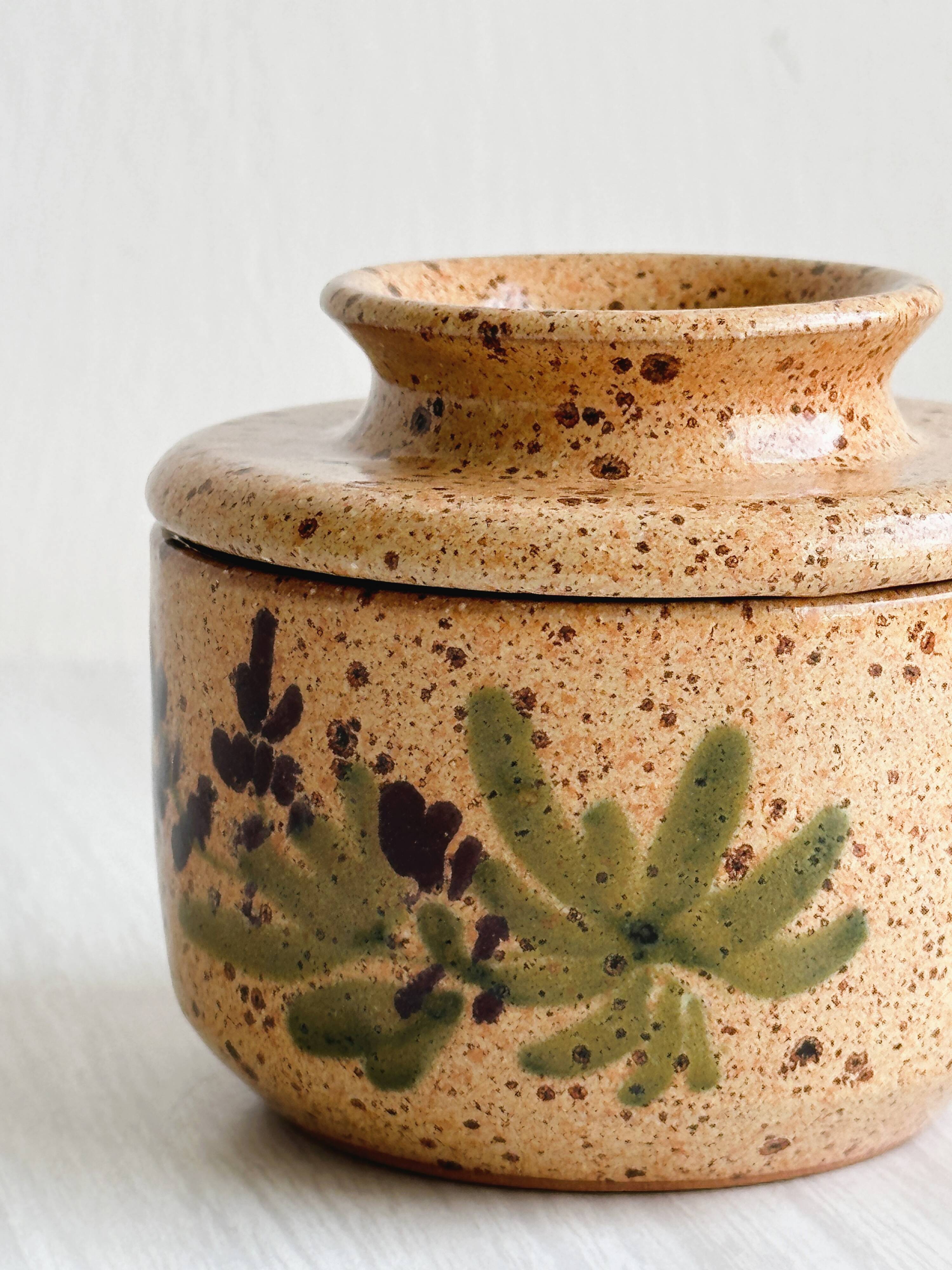 Small speckled ceramic butter dish, hand-painted decoration.