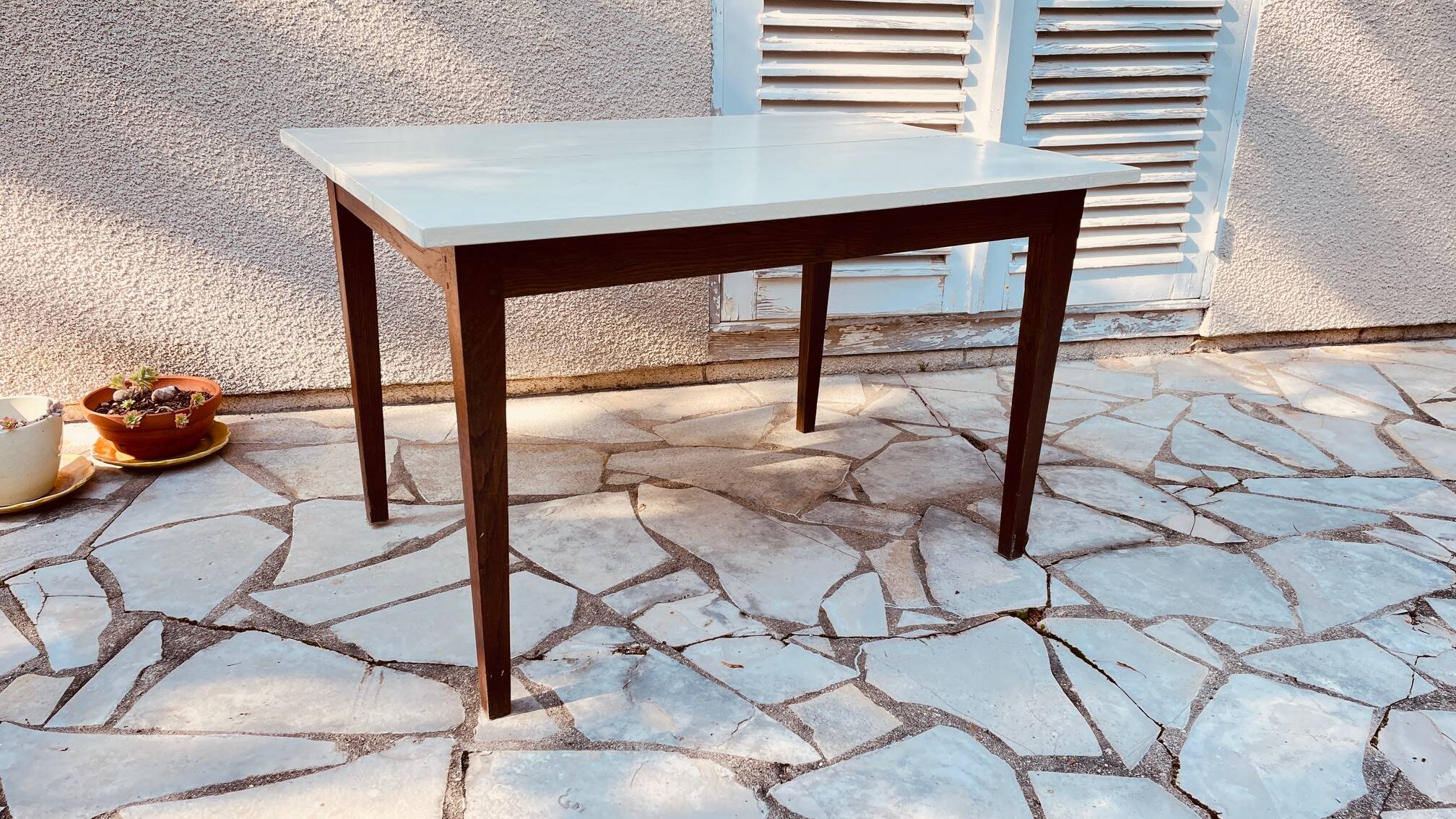 Vintage oak farmhouse table with a white top.