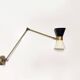 Articulated brass and lacquered iron wall light, 1950s design.