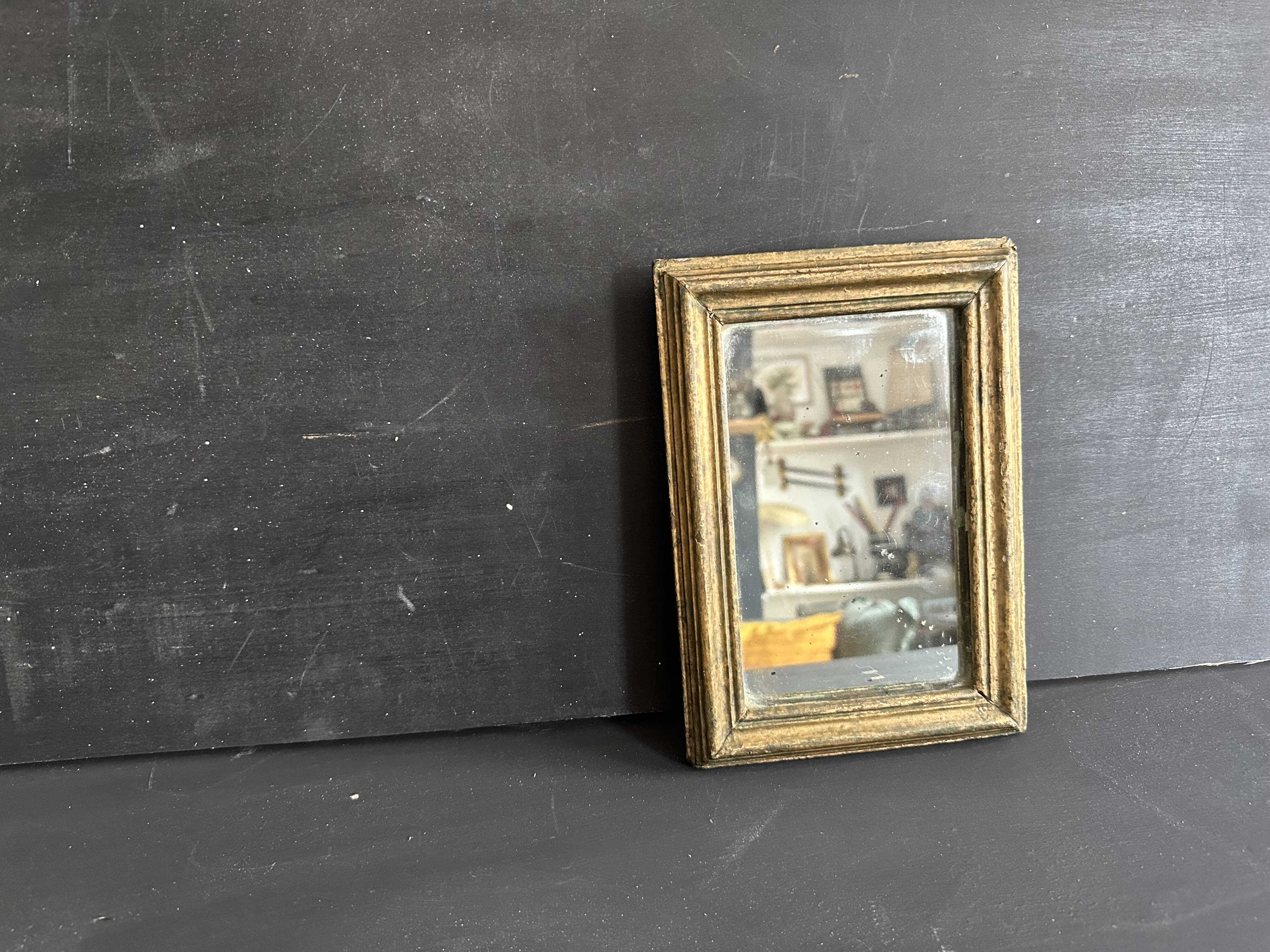 Miniature mirror from the 18th century in gilded wood, mercury glass.