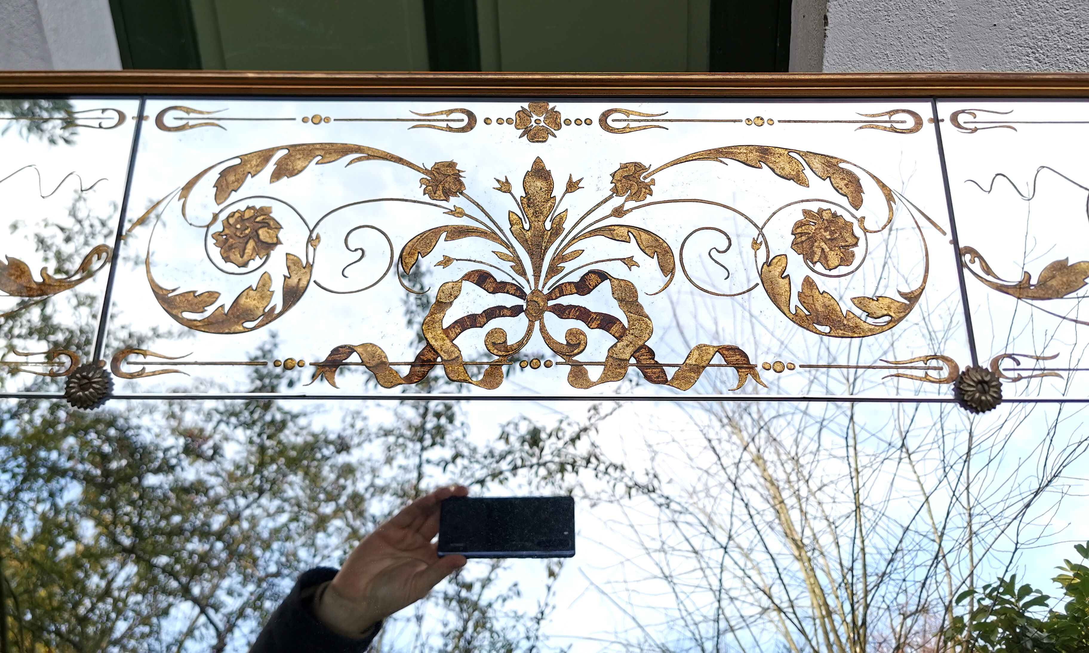 Glass mirror with a decoration engraved with golden foliage 1960