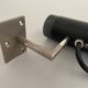 Minimalist black metal wall light with a cylindrical design, 1960s, Germany.