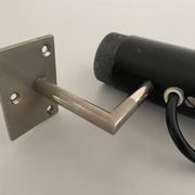 Minimalist black metal wall light with a cylindrical design, 1960s, Germany.