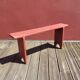Banc ancien en bois peint en rouge