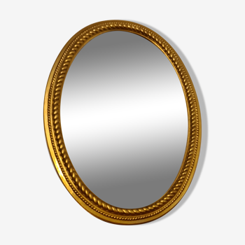 Beveled oval mirror in gilded wood 78×58cm