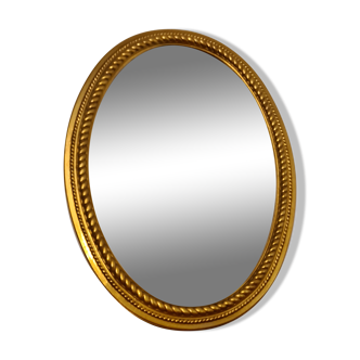 Beveled oval mirror in gilded wood 78×58cm
