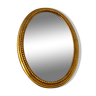 Beveled oval mirror in gilded wood 78×58cm