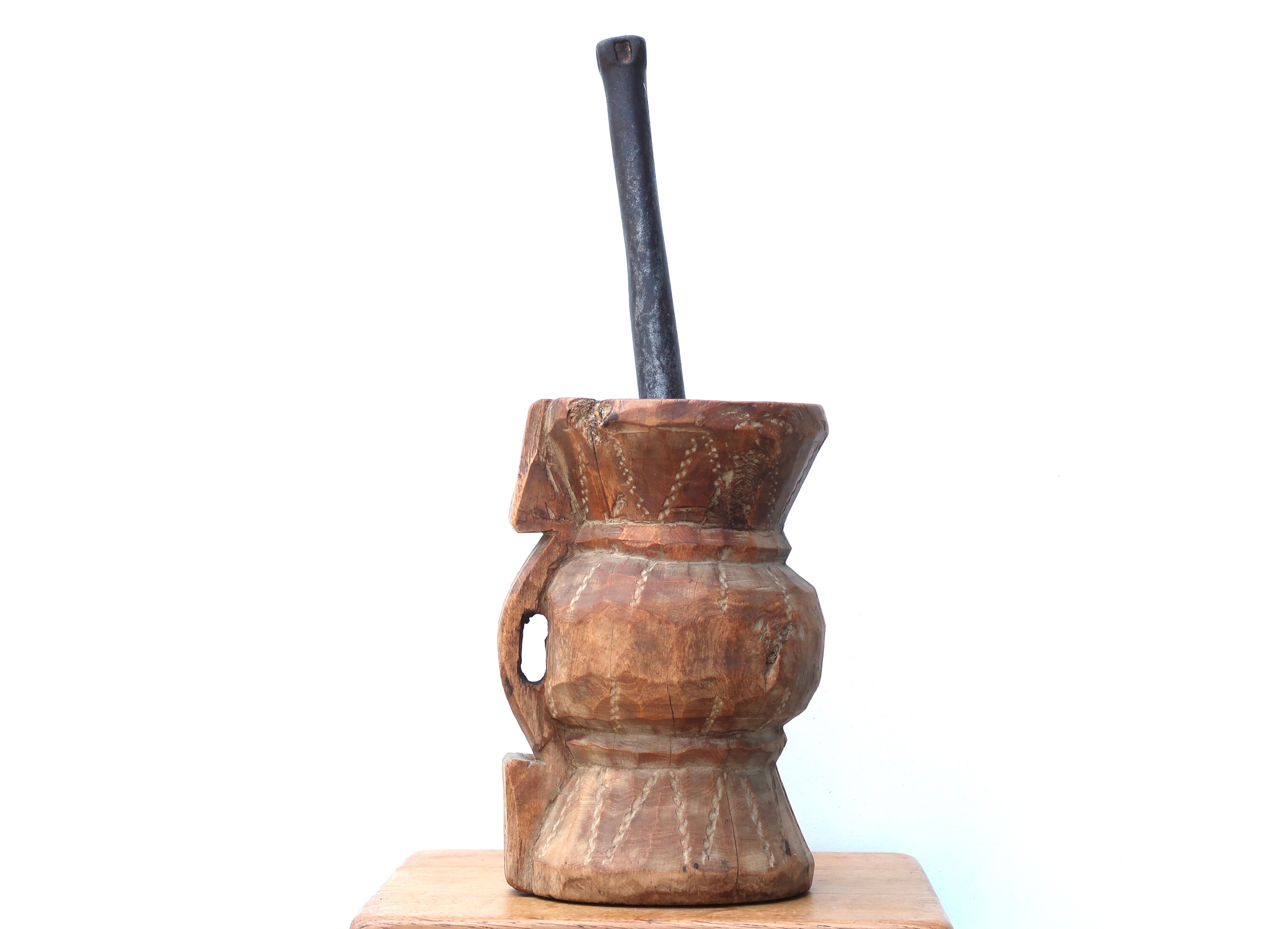 African mortar in carved wood, cast iron pestle, 70s