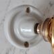 Glass tulip bathroom wall lamp and white porcelain base early XXth