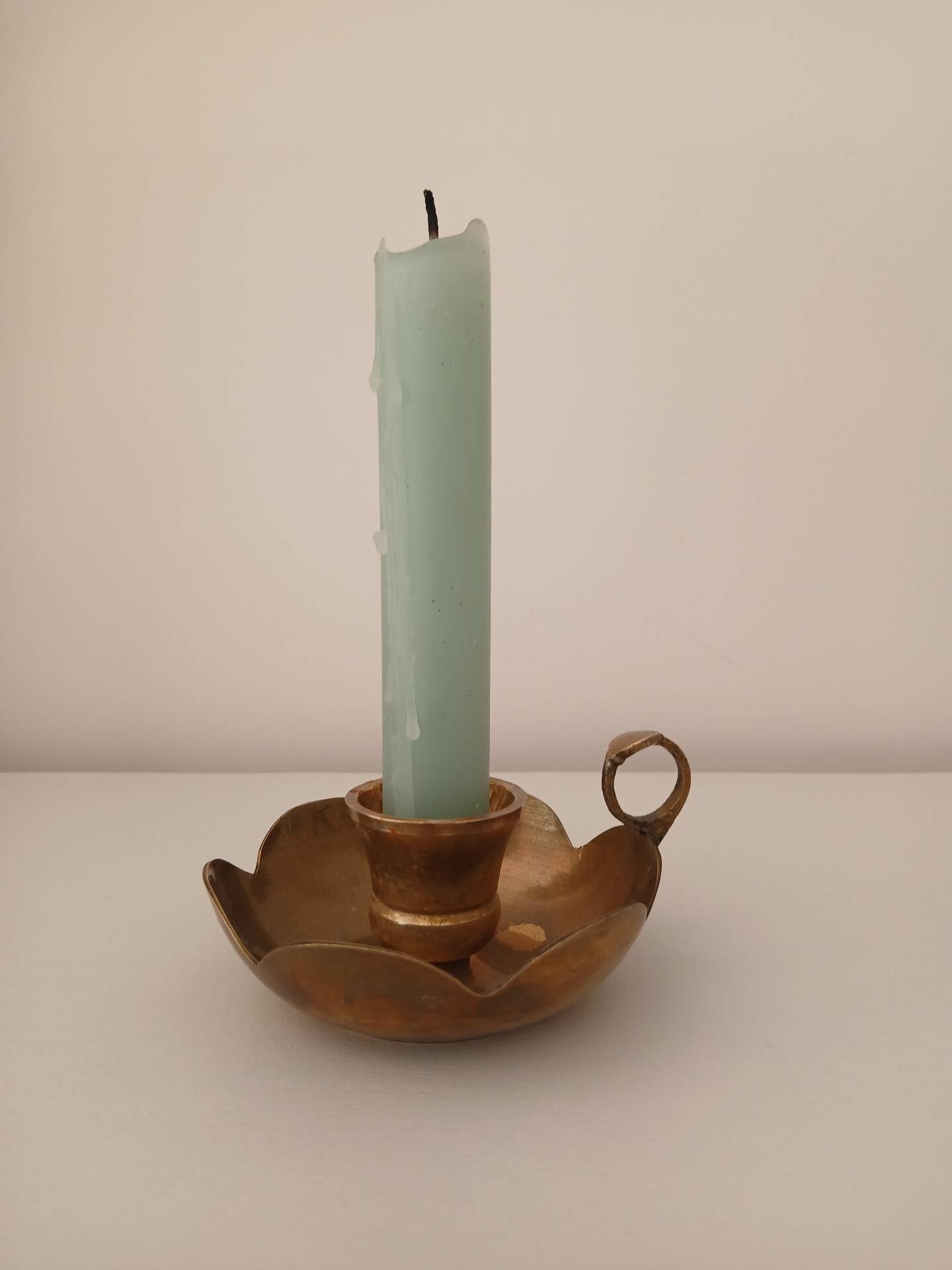 Brass candle holder in the shape of a flower.