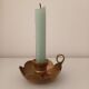 Brass candle holder in the shape of a flower.