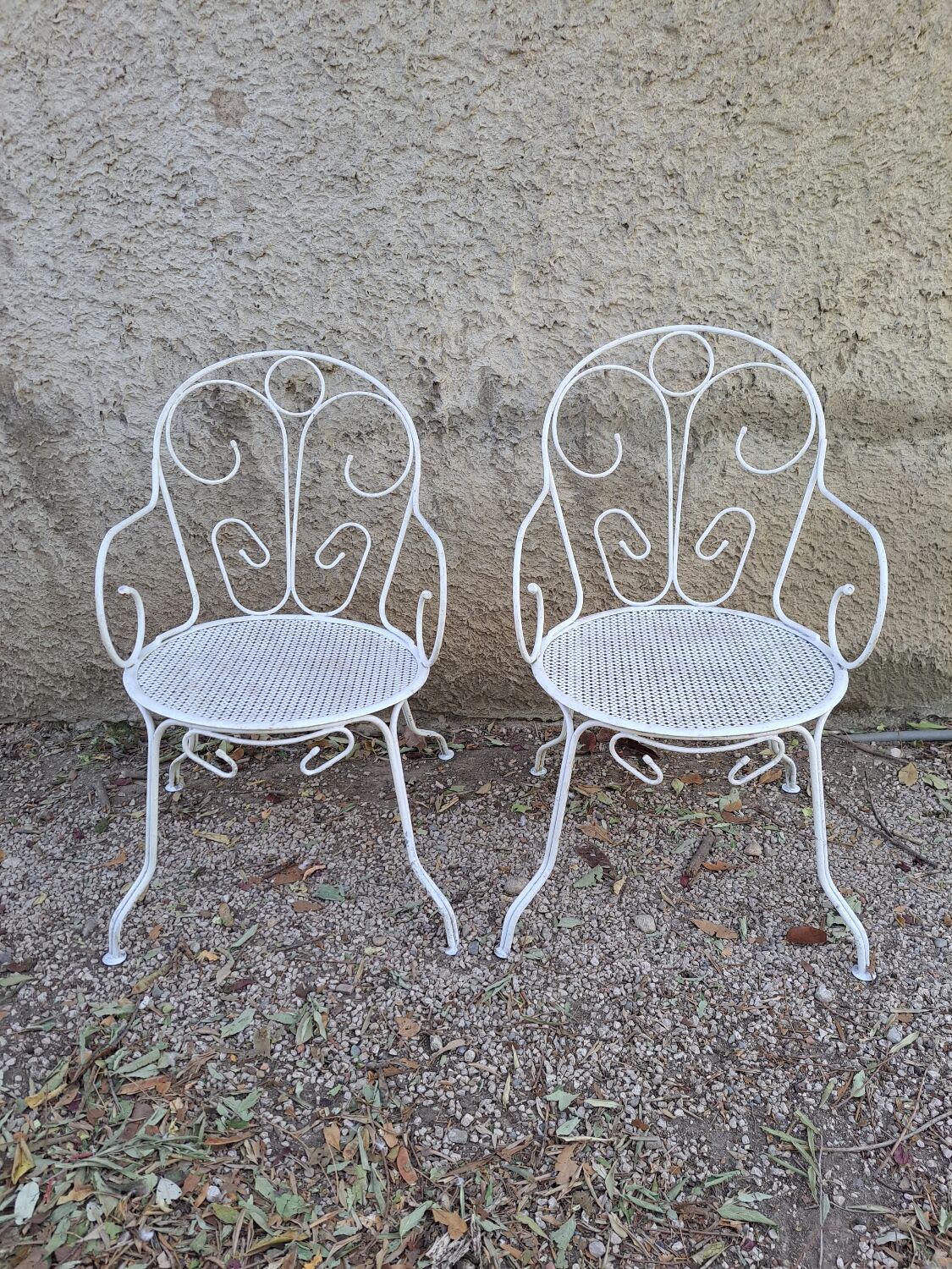 Pair of old white iron armchairs