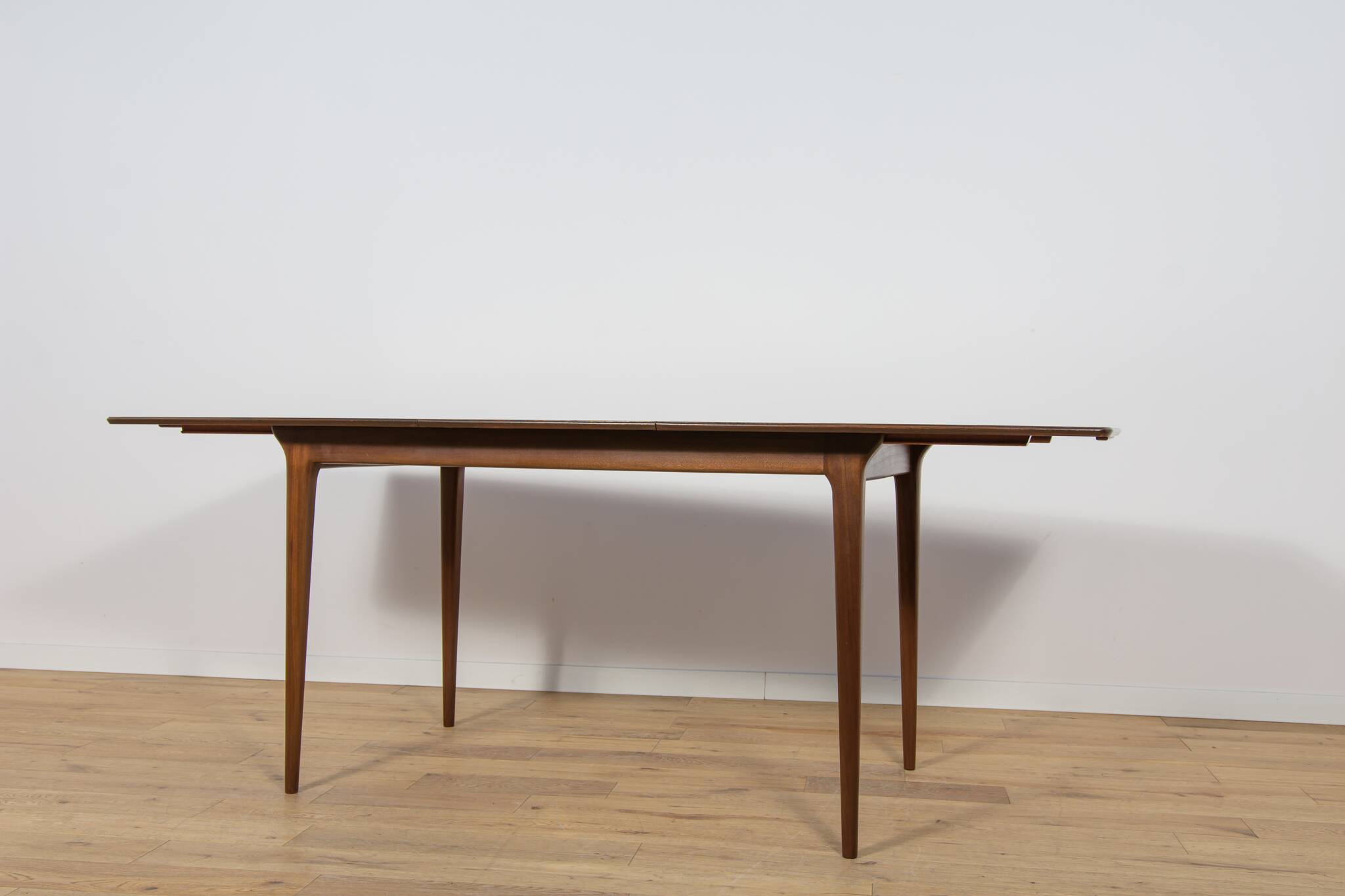 Extendable teak dining table in Mid-Century style from McIntosh, UK.
