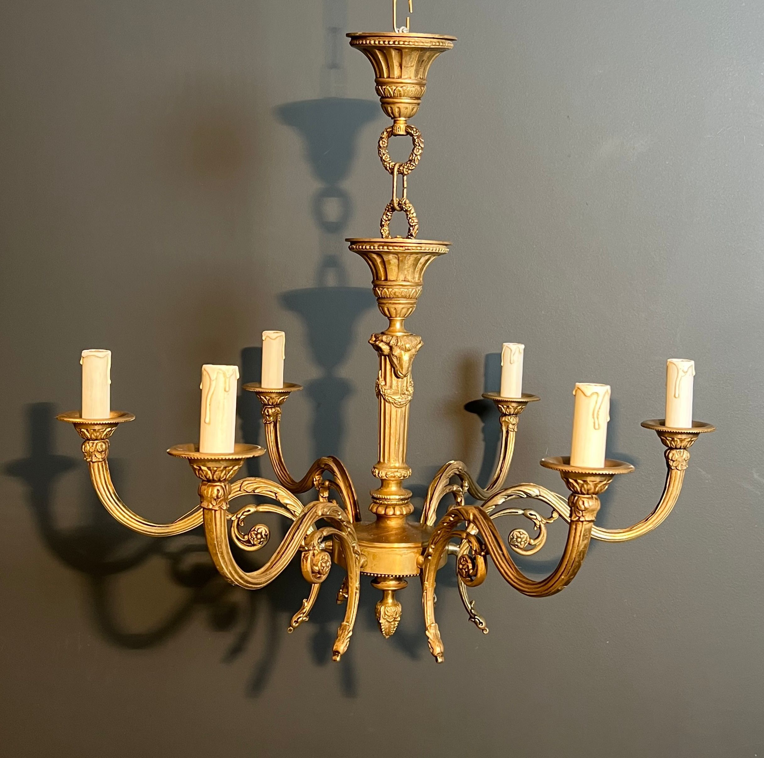 Bronze chandelier with ram's head motifs in the Louis XVI style, in the manner of Maison Jansen.