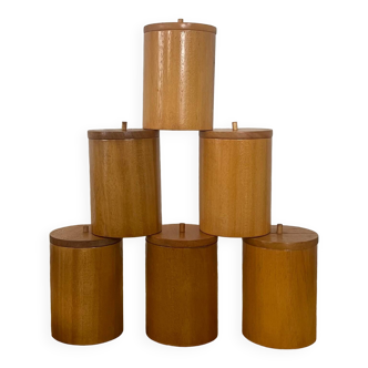 6 wooden spice jars.