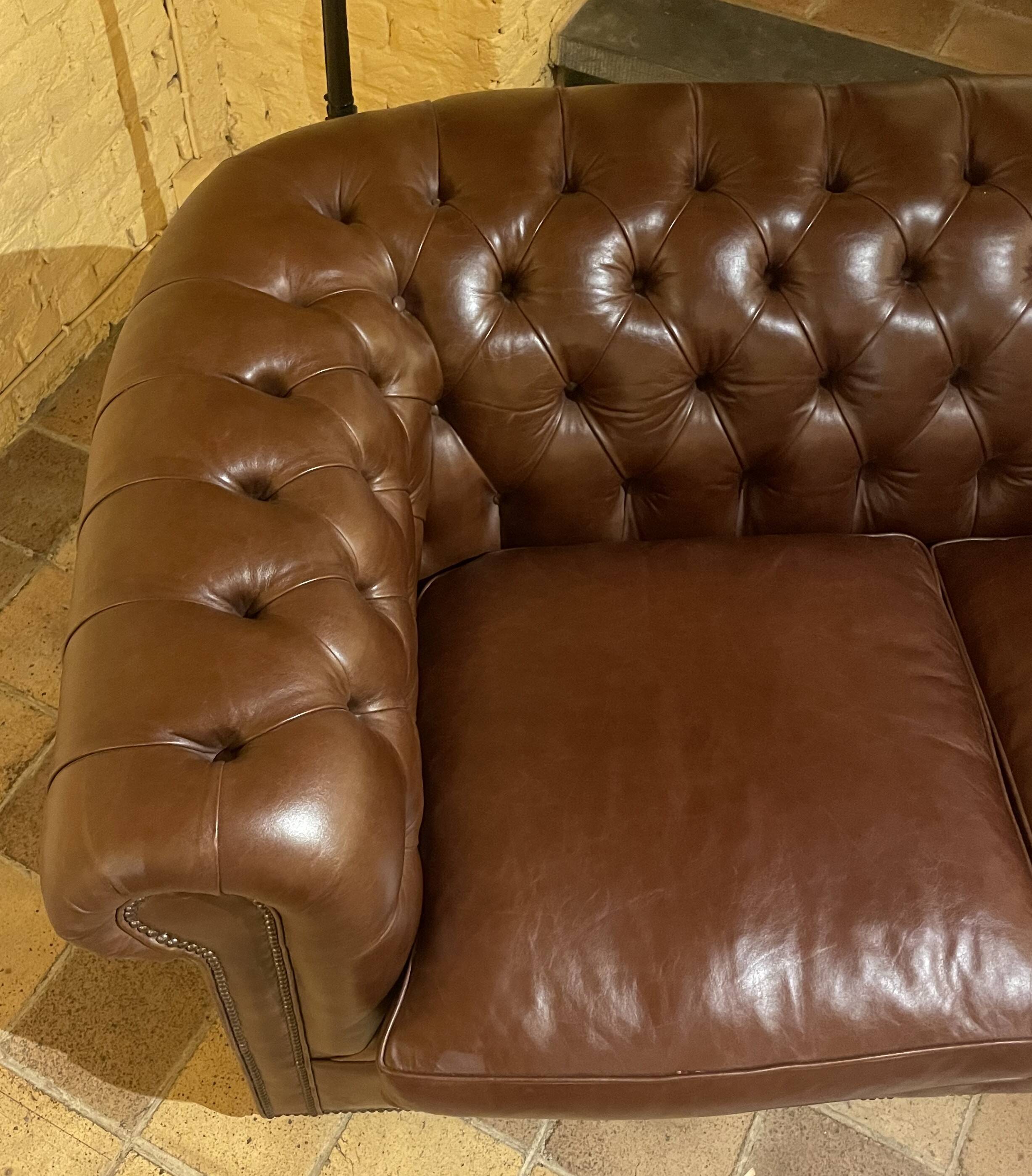 brown leather 2-seater Chesterfield sofa