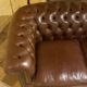 brown leather 2-seater Chesterfield sofa