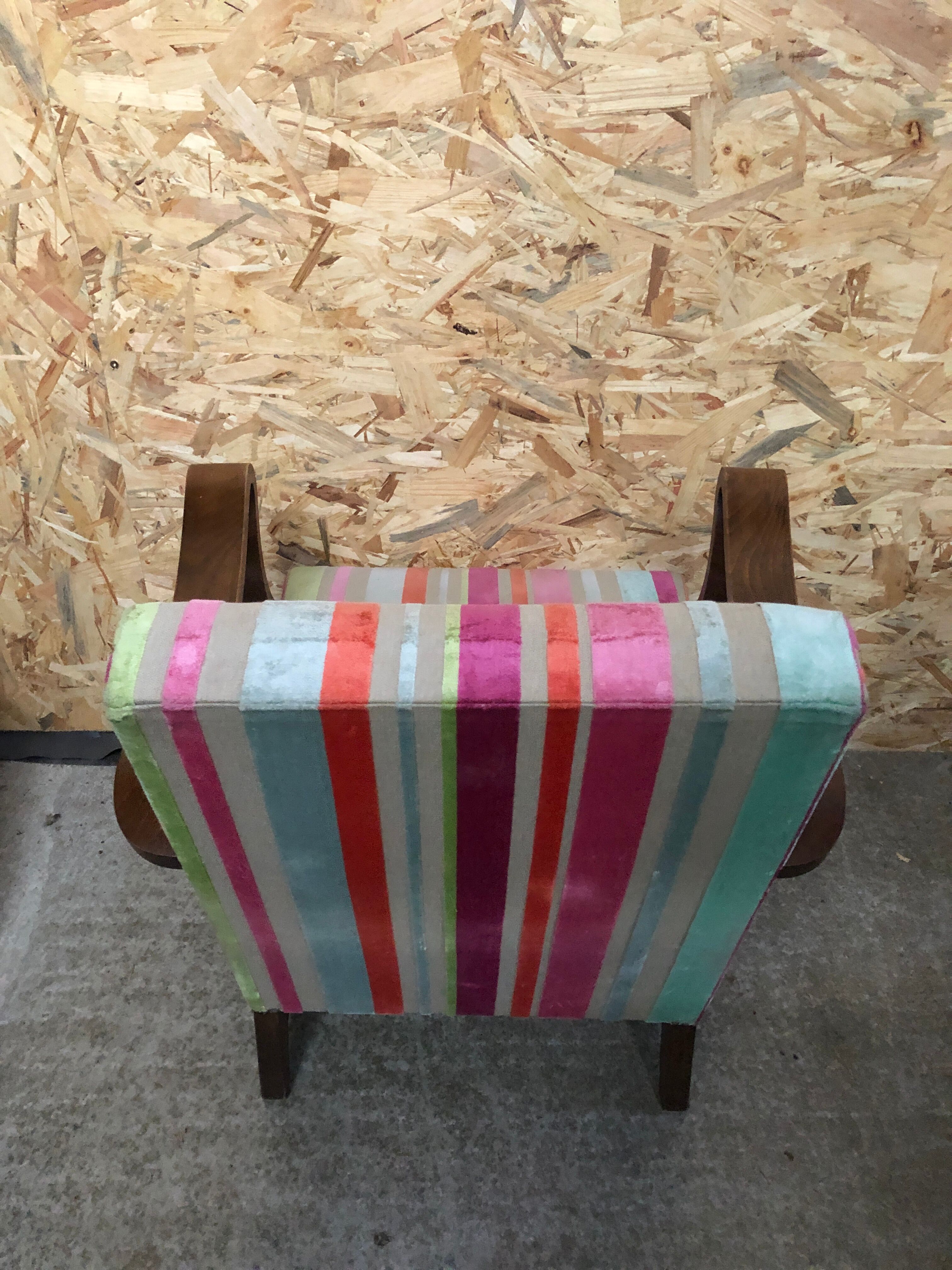 Old wooden armchair with curved armrests