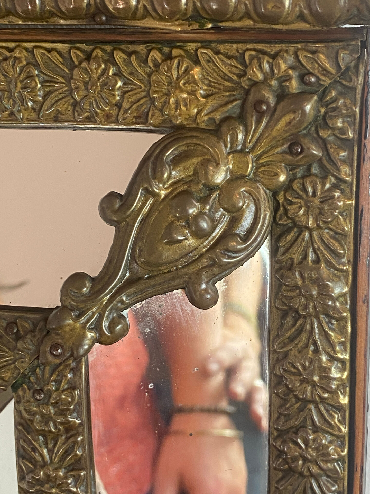 Mirror with brass repoussé frame