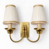 Vintage wall sconces in brass with pleated fabric shades.