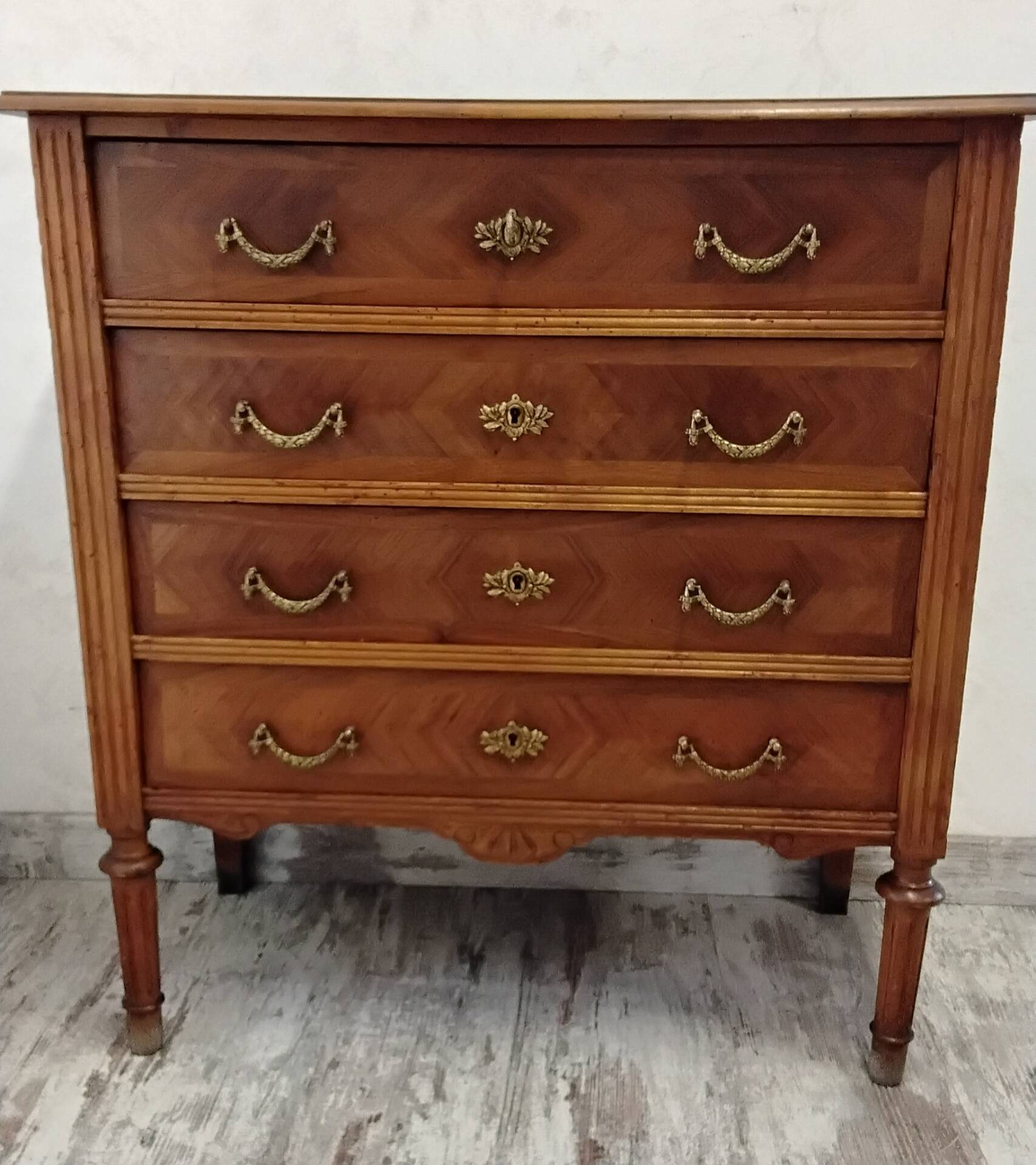 Antique marquetry commode in the Louis XVI style.