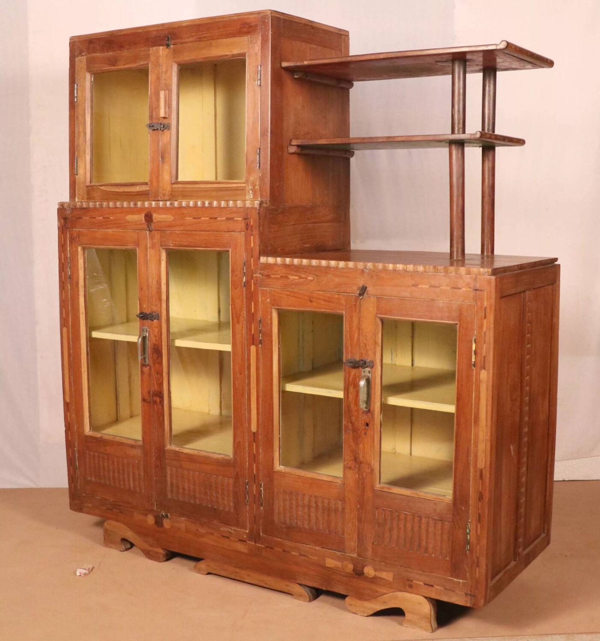 Antique Art Deco display cabinet in Burmese teak with original yellow patina interior.
