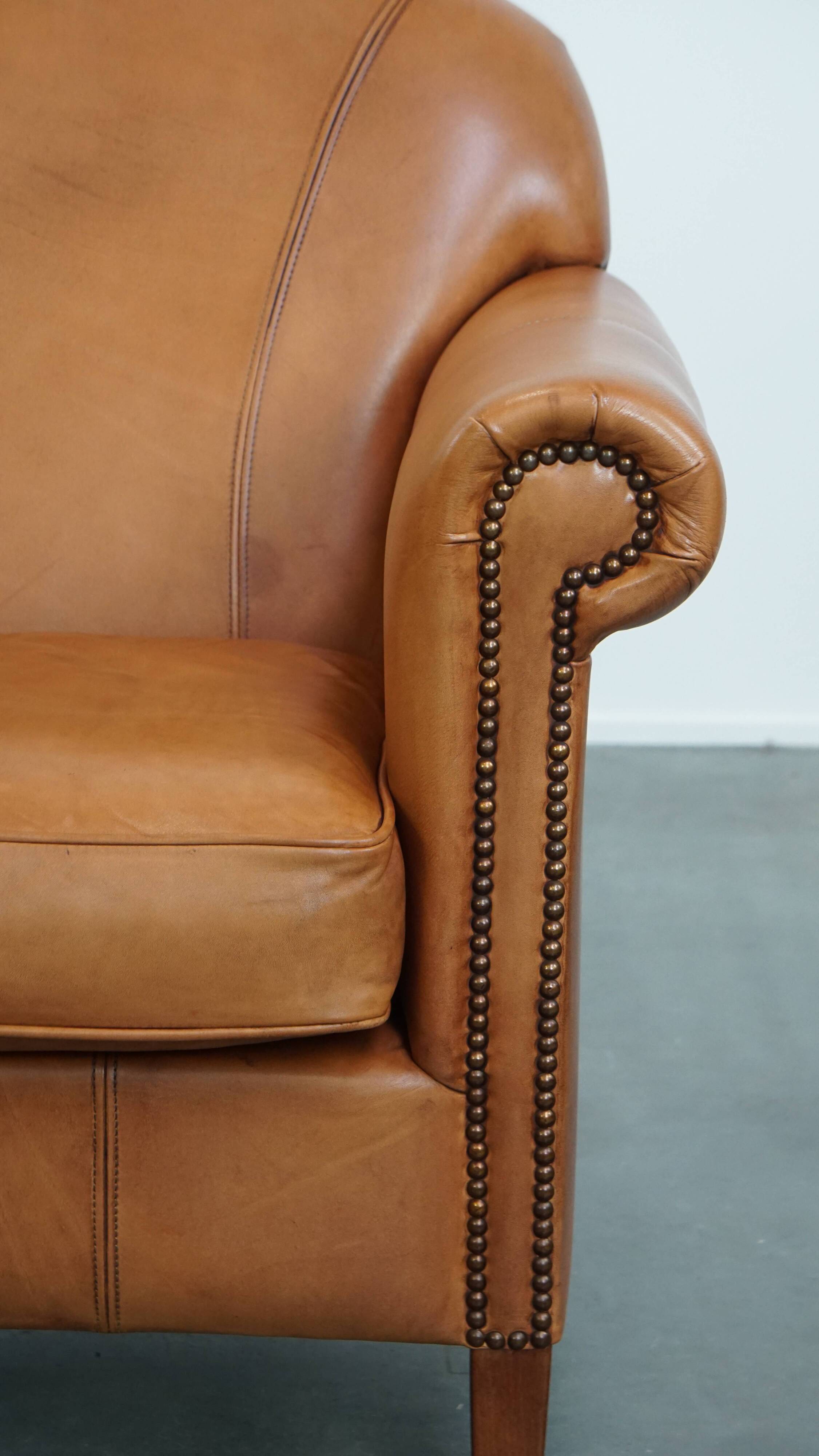 Cognac-colored cowhide leather armchair