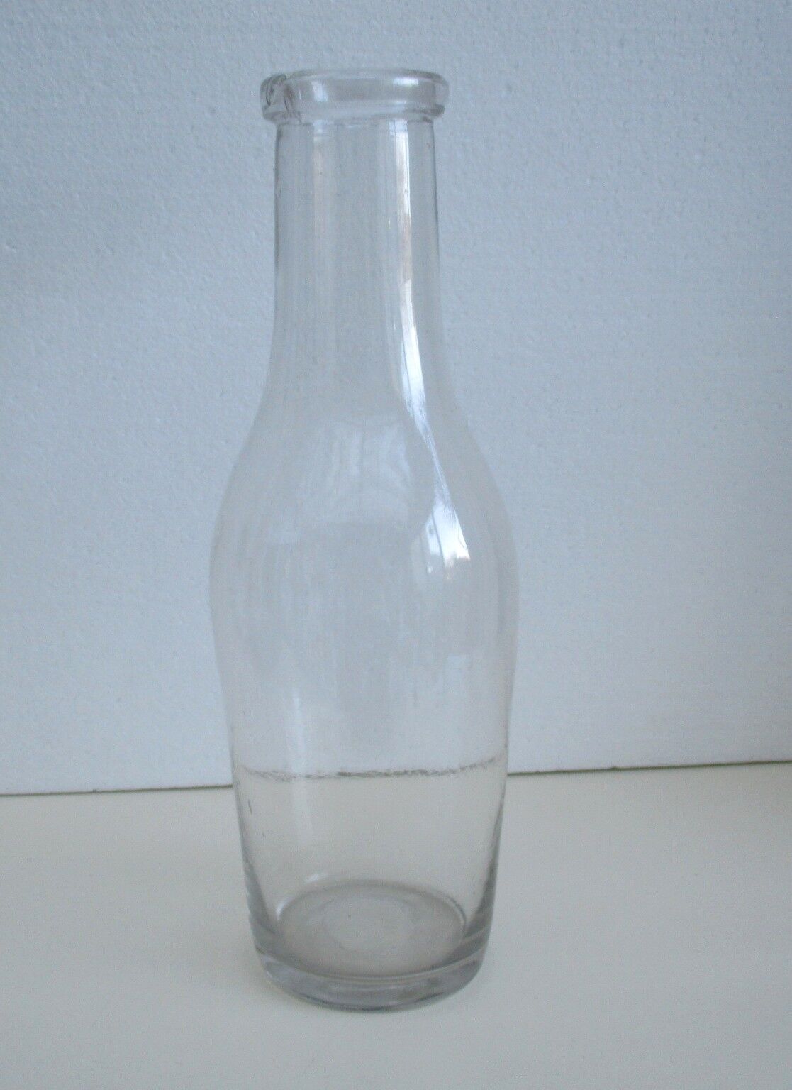 Large antique bottle made of blown glass