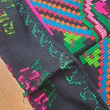 Handwoven colorful Romanian carpet, green and black background with gorgeous colorful flowers