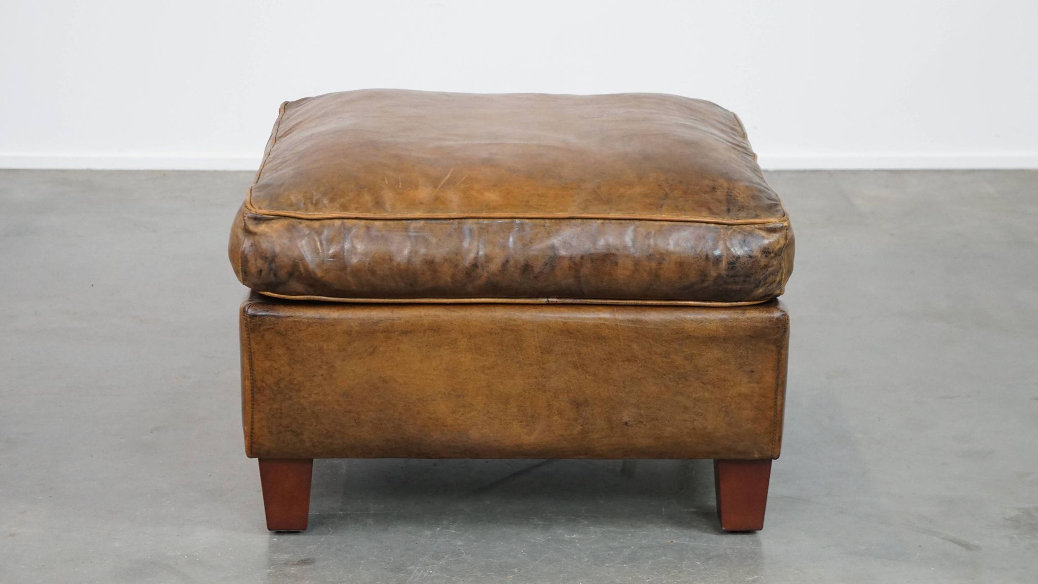 Sheepskin wing chair + XXL patinated footrest