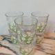 Orangeade service with a jug and six glasses featuring a daisy pattern.