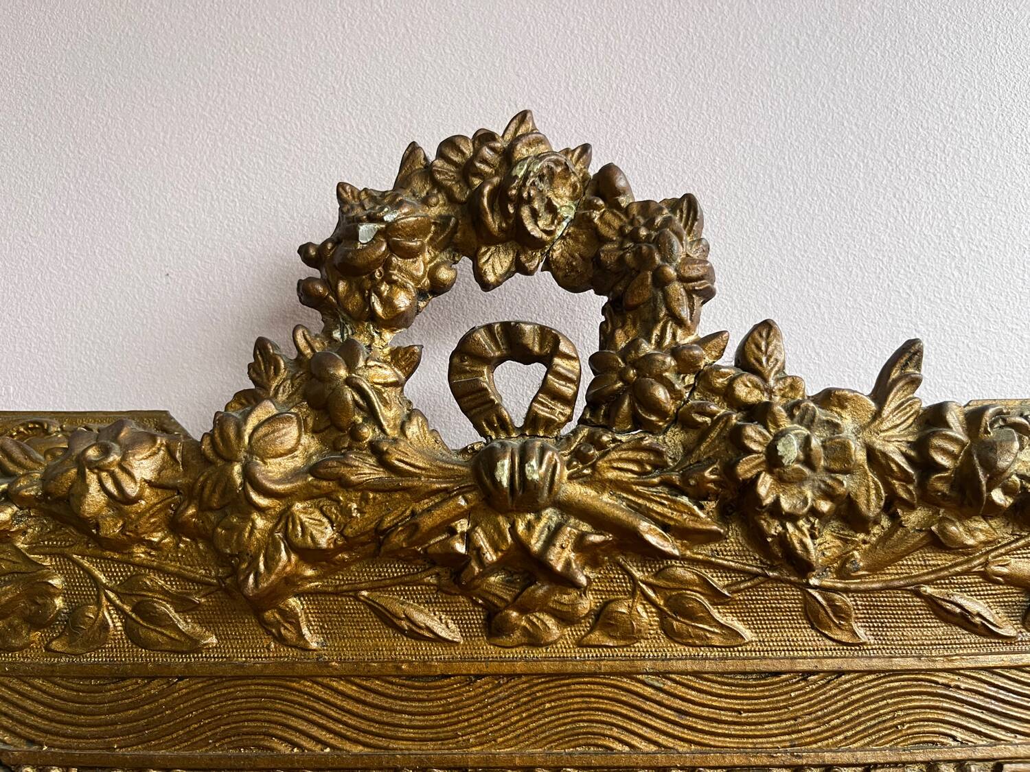 Golden trumeau mirror for fireplace, late 19th century, with sculpted pediment.