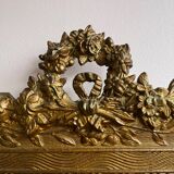 Golden trumeau mirror for fireplace, late 19th century, with sculpted pediment.