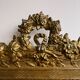 Golden trumeau mirror for fireplace, late 19th century, with sculpted pediment.