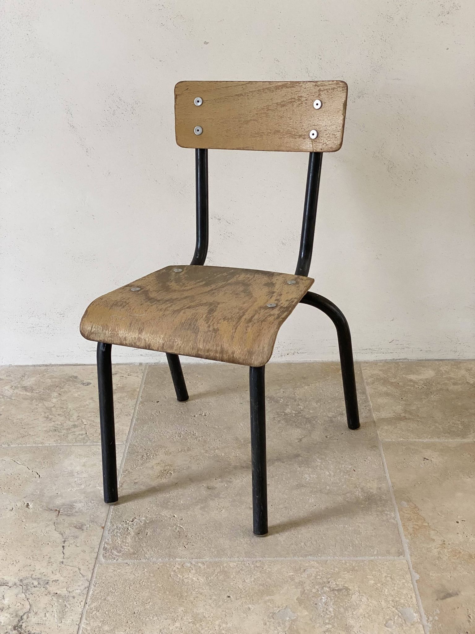 Vintage children's school chair in wood and black metal, industrial style.