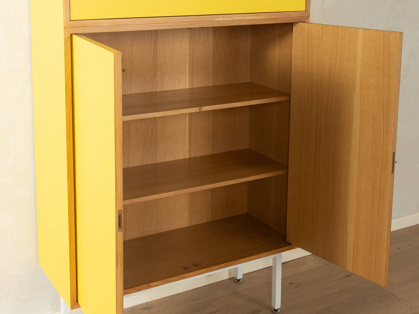 Classic sideboard from the 1960s, oak veneer, yellow Resopal, white steel feet